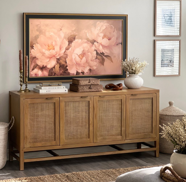Blake 68-inch light brown teak and rattan storage media console beneath a framed floral artwork